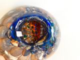 a person holding a glass vase with a picture inside of it