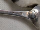 two spoons that are sitting on a table