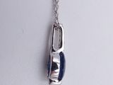 silver necklace with a blue glass pendant hanging from it ' s chain