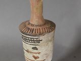 a vase that is sitting on a table with a gray background