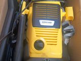 a yellow and black power washer in a cardboard box