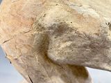 a sculpture of a head made of wood on a table