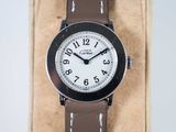 a close up of a wrist watch with a brown strap
