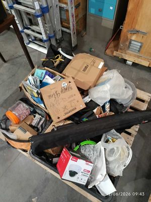 a black umbrella sitting on a pallet in a warehouse
