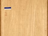 a picture of a wooden cabinet with a blue sticker on it