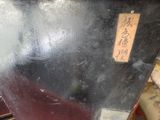 a black suitcase sitting on top of a wooden table