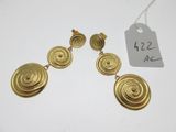 a pair of gold earrings with spiral designs on them