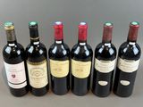 six bottles of wine lined up in a row on a table