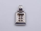 silver plated pendant with a black and white design on a white background