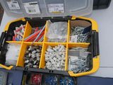 a yellow tool box filled with assorted screws and nuts