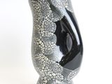 a black and white vase with a cracky design on it