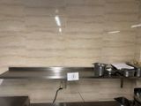 an image of a commercial kitchen with stainless steel counter tops