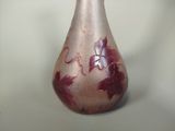 a glass vase with a pink and purple design on it