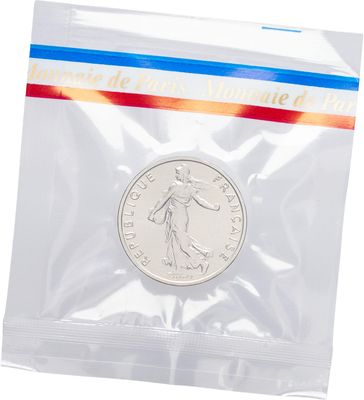 a silver coin in a clear plastic bag on a white background