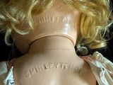 a close up of a doll ' s back with a tattoo on it