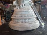 a statue of a lion on a pedestal with a ribbon around it