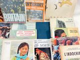 several children ' s books are stacked on a white surface