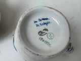 a small cup that has a blue and white design on it