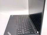 a laptop with a black keyboard on a white surface