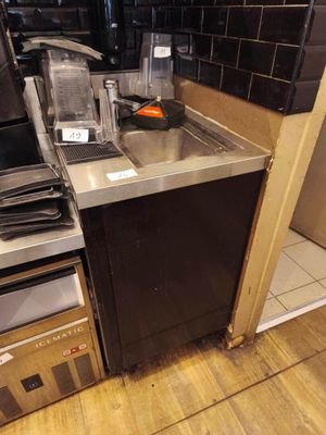 a small kitchen with a stove, sink, microwave, and dishwasher