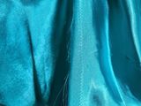 a close up picture of a person wearing a blue dress