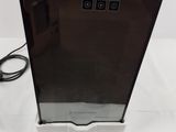 an image of a black refrigerator sitting on top of a white table