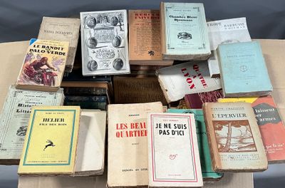 a lot of books on a table that are sitting on top of each other
