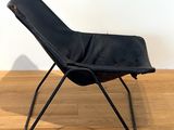 a black chair that is sitting on a wooden floor