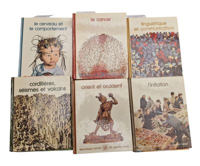 several books are stacked on top of each other on a white surface