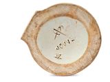 a white plate with writing on it on a white surface