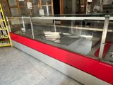 a glass display case in the middle of a store