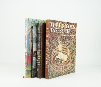 two books sitting on top of each other in front of a white background