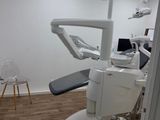 a dentist ' s chair in the corner of the room