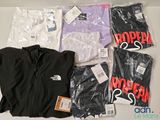 a lot of clothing that is sitting on a table