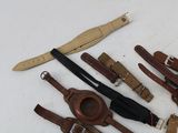 a lot of leather items that are laying out on the table