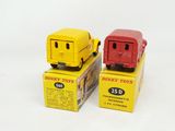 two toy cars sitting on top of boxes on a white surface