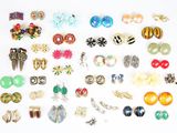 many pairs of earrings and earrings on the table