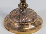 a gold candle holder on a white table
