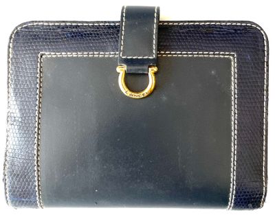 black leather wallet with a gold ring on the front of it