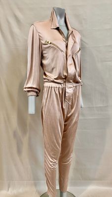 an image of a mannequin wearing a pink suit on a mannequin stand