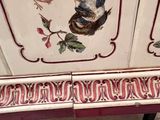 two birds painted on the side of a cabinet
