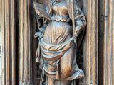 a statue of a woman holding a fan on a pedestal