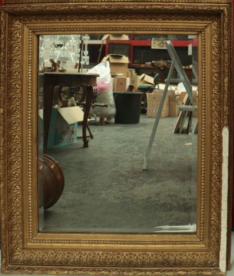 a mirror that is sitting on the floor in a room