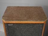 a close up of a brown and black speaker sitting on top of a table