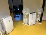 une pièce équipée de deux ventilateurs et d'un petit climatiseur