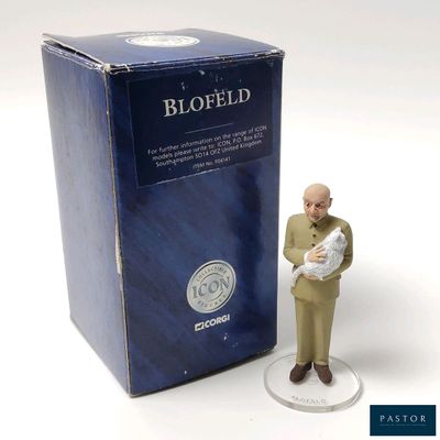 a figurine of a man holding a baby in front of a box