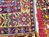 two rugs with different colors and patterns are on the floor