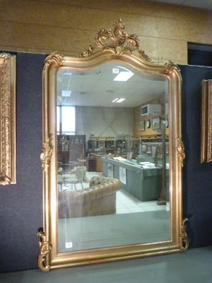 a large gold mirror in the middle of a room