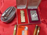 a box with a lighter, lighter and other items on a red cloth
