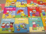 several children ' s books are lined up on a table